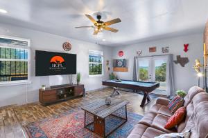 a living room with a couch and a pool table at Scenic Terrace in Canyon Lake