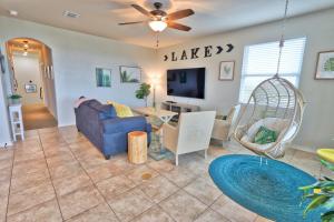 a living room with a blue couch and a swing at Scenic Terrace in Canyon Lake +30 photos