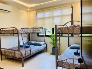 a room with two bunk beds and a window at Camp J Staycation in Cayucay