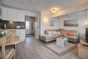 a living room with a couch and a kitchen at Fewo Luv in Kühlungsborn