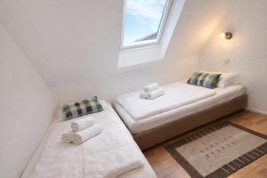 a small room with two beds and a window at Fewo Luv in Kühlungsborn