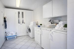 a white laundry room with a washer and dryer at Fewo Luv in Kühlungsborn