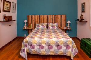 a bedroom with a large bed with a wooden headboard at Casa da Curuxeira in Santiago de Compostela