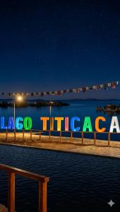 a sign that says la tucada at night at uros royal logde in Puno