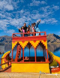 a group of people on a boat on the water at uros royal logde in Puno