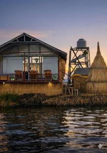 a house on the water with chairs on it at uros royal logde in Puno