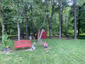 a park with a red bench and a red barn at The Oasis in Clinton