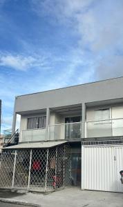 a building with a fence in front of it at Vila do Chaves Sr Barriga 70 in Itajaí