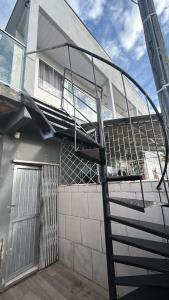 a spiral staircase in front of a building at Vila do Chaves Sr Barriga 70 in Itajaí +1 photo