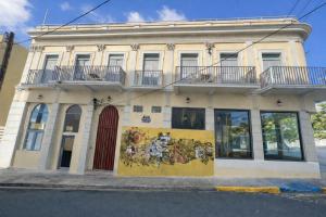 a building with a painting on the side of it at Nando's Place in San Juan