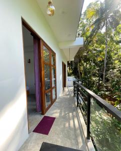 a balcony of a house with a door at Coffee Shade in Midigama East