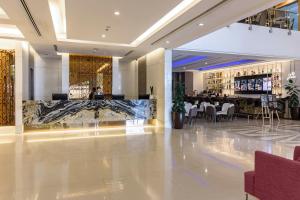 a hotel lobby with a bar and a restaurant at Jasmine Grande Residence Suite Bangkok in Bangkok