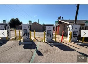 a row of gas pumps in a parking lot at El Muir Motel in Fresno