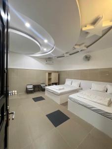 a large room with two beds and a ceiling at Cảnh Việt Hotel in Tây Ninh +17 photos