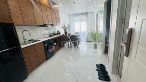 a kitchen with a table and chairs in it at Sunrise Home in Xóm Niêm +3 photos