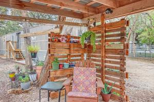 a pergola with a table and chairs in a yard at Wild Rhodes in Wimberley