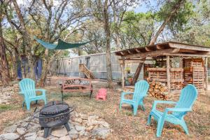 a group of chairs and a grill in a yard at Wild Rhodes in Wimberley +22 photos