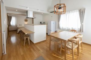 a kitchen and dining room with a table and a refrigerator at Sa one ko Matsumoto Entire house Free parking 2cars in Matsumoto