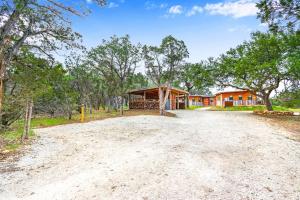 an empty road in front of a house at Wild Candy-Plum Wild in Wimberley