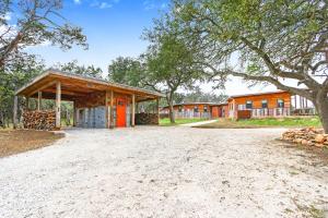 a barn with a building in the background at Wild Candy-Plum Wild in Wimberley