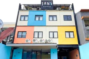 a colorful building with a sign on it at SANS FYBED Hotel Semarang in Semarang