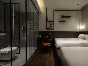 a hotel room with two beds and a shower at SEENERGY STAY Riverside in Phnom Penh +38 photos