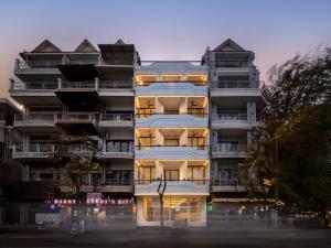 a tall apartment building with its lights on at SEENERGY STAY Riverside in Phnom Penh