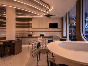 a lobby with a table and chairs and a bar at SEENERGY STAY Riverside in Phnom Penh