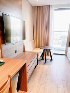 a hotel room with a large television and a table at Blue View Apec Tuy Hoa in Tuy Hoa +13 photos
