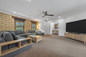 a living room with a large flat screen tv at Route 86 Bright in Bright