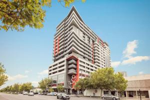 a rendering of a tall building with a sign on it at Two Bedroom Unit in Central Adelaide in Adelaide