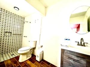 a bathroom with a toilet and a sink and a mirror at Stella del Mar in San Felipe