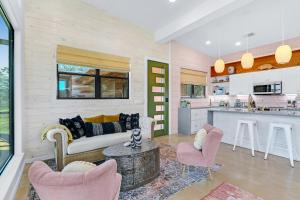 a living room with a couch and chairs and a kitchen at Wild Candy-Blue Yodel in Wimberley