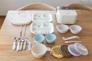 a table with dishes and utensils on a table at Sa one ko Matsumoto Entire house Free parking 2cars in Matsumoto