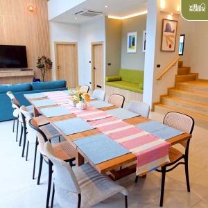 a dining room with a long table and chairs at Villa Nordic Private Pool Pakchong in Ban Thung Sawang
