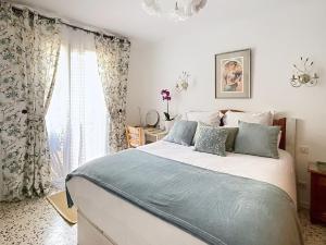 a bedroom with a large bed and a window at Sejour paisible au Thor in Le Thor