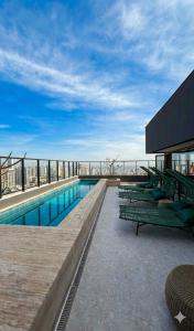 a swimming pool on the roof of a building at Azure Aesse Hospitality Marista in Goiânia