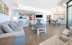 a living room with a couch and a table at Phoenix West 603 in Orange Beach