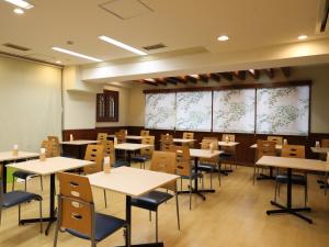 an empty classroom with tables and chairs at Smile Hotel Nihombashi Mitsukoshimae in Tokyo