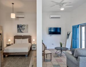 a bedroom and a living room with a bed and a couch at Casa Pelayo in San Juan