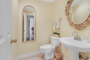 a bathroom with a sink and a toilet and a mirror at Whispering Ridge Ranch in Wimberley