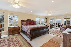 a bedroom with a bed and a living room at Whispering Ridge Ranch in Wimberley