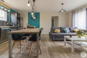 a kitchen and living room with a table and a couch at Les bichous in Saint-Thomas +23 photos