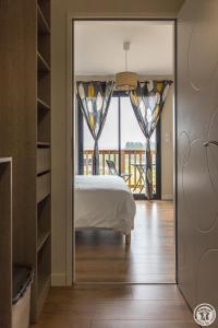 a bedroom with a bed and a view of a balcony at Les bichous in Saint-Thomas