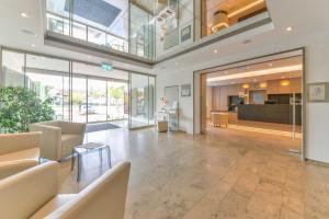 a lobby of a building with couches and tables at ateckhotel Kirchheim/Teck in Kirchheim unter Teck