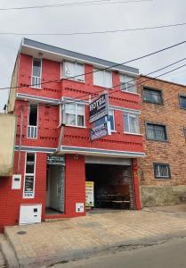 a red brick building with a sign on it at Bohemia Hotel in Tunja