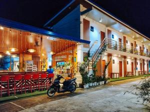 a motorcycle parked outside of a building at night at RedDoorz at Balai Malinawon Siargao in General Luna