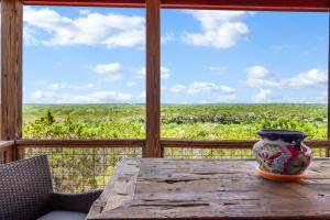 a vase sitting on a wooden table on a porch at Valley View in Fischer