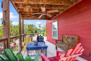 a porch with a table and chairs and a ceiling fan at Valley View in Fischer +22 photos