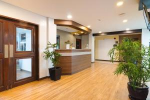 an office lobby with potted plants and a counter at Microtel by Wyndham Batangas in Santo Tomas